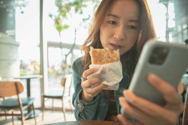 istock Woman Using Smart Phone At Coffee Shop 1272377336