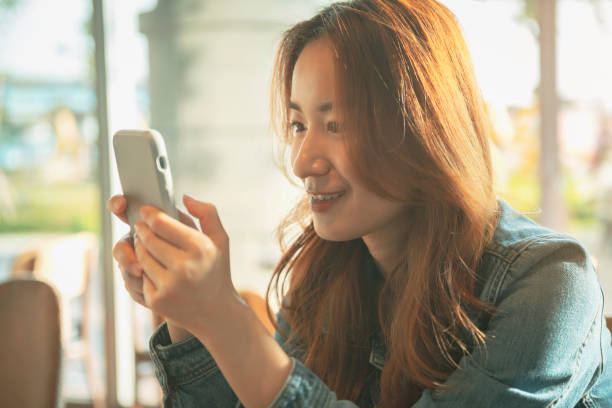 istock Woman Using Smart Phone At Coffee Shop 1272377356