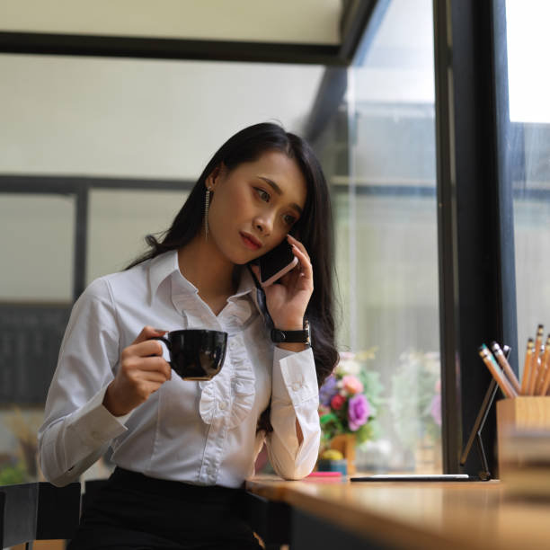 istock Female freelancer talking on the phone while take a coffee break 1272379938