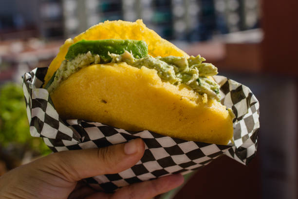 Someone eating arepa on a sunny day