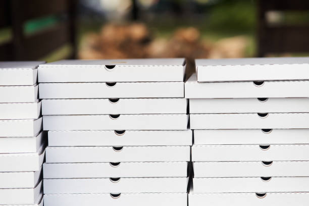 istock Stack of white cardboard pizza packages. Pizza packages close-up 1272380056
