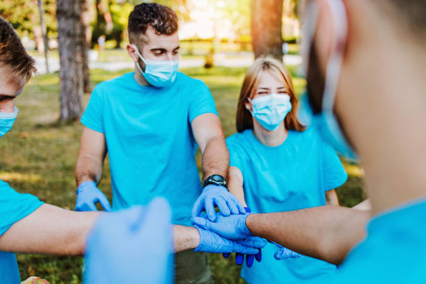 istock Volunteers with garbage bags cleaning up garbage outdoors - ecology concept. 1272380523