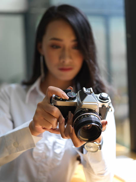 istock Female journalist taking photo for her report with digital camera 1272381177