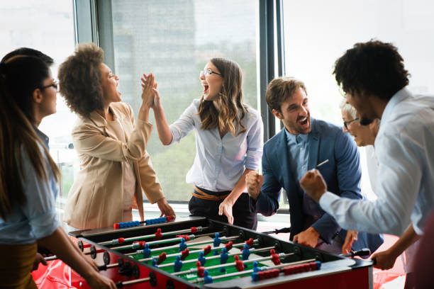 istock Excited diverse employees enjoying funny activity at work break, creative friendly workers play game 1272381262