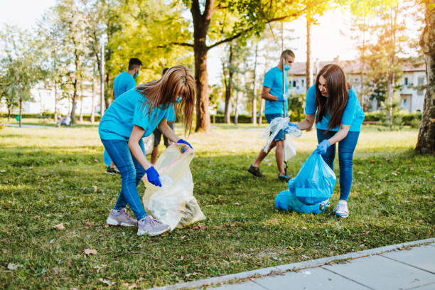 istock Volunteers with garbage bags cleaning up garbage outdoors - ecology concept. 1272381702