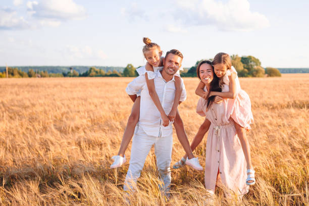 istock Happy family playing in a wheat field 1272382874