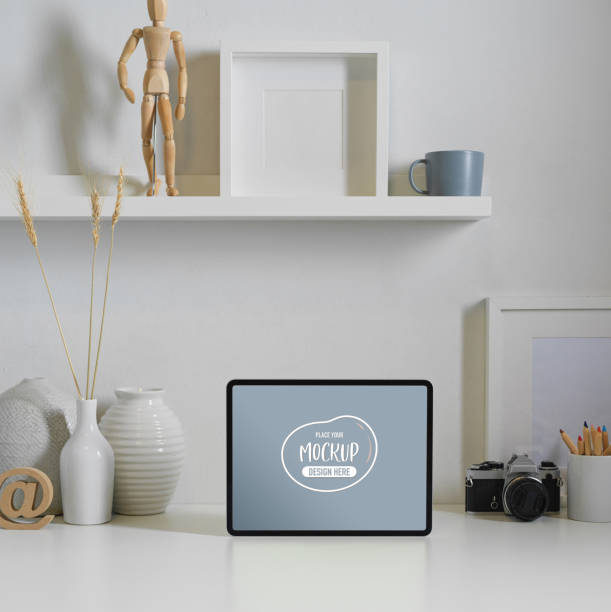 istock Worktable with mock up digital tablet, camera, decorations and copy space in home office 1272383048