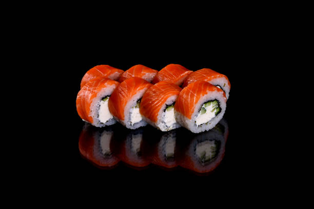 istock Fresh delicious beautiful sushi rolls on a dark background 1272384151