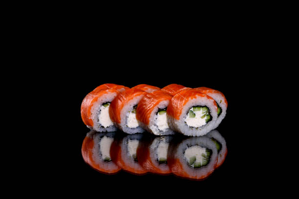 istock Fresh delicious beautiful sushi rolls on a dark background 1272384158