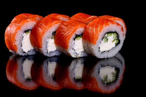 istock Fresh delicious beautiful sushi rolls on a dark background 1272384166