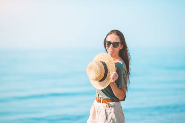 istock Young woman in white on the beach 1272384679