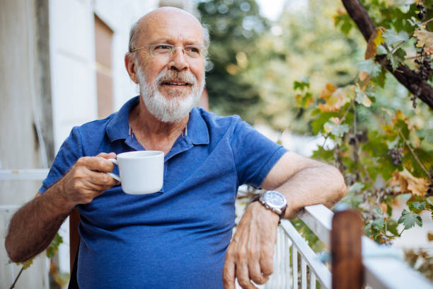 istock Smiling mature man enjoying in morning coffee on a terrace 1272384802