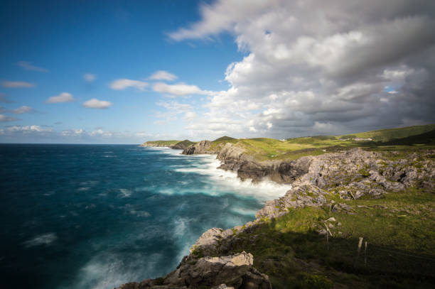 istock A beautiful scenery of rocky cliffs by the sea under a cloudy sky 1272388801