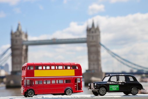 Close-up view of public transport figurines with London Bridge in the background