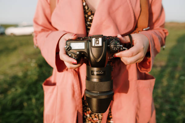 istock Woman holding a DSLR camera 1272394230