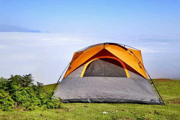 istock Tent on a mountain top in the morning, beyond the clouds 1272395766
