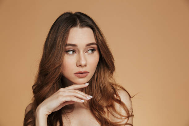 istock Confident beautiful woman looking aside while standing shirtless isolated 1272395925