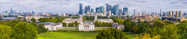 London Canary Wharf City skyscrapers overlooking Thames Greenwich panorama UK Aerial panoramic vista across Greenwich Park and the River Thames to the crowded skyscraper cityscapes of Canary Wharf and the City of London financial district, UK. canary wharf photos stock pictures, royalty-free photos & images