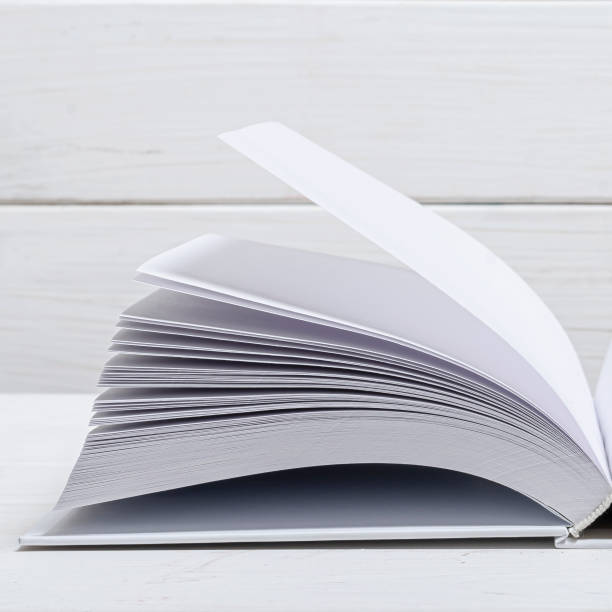istock White new open book with clean empty pages lies on a wooded table 1272400203