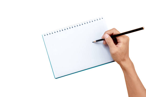 istock Hand with pencil writing in the book 1272400623