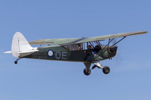 Lethbridge, Australia - November 23, 2014: Piper J-3C-65 Cub (Piper L-4 grasshopper) single engine light aircraft taking off from Lethbridge airfield.