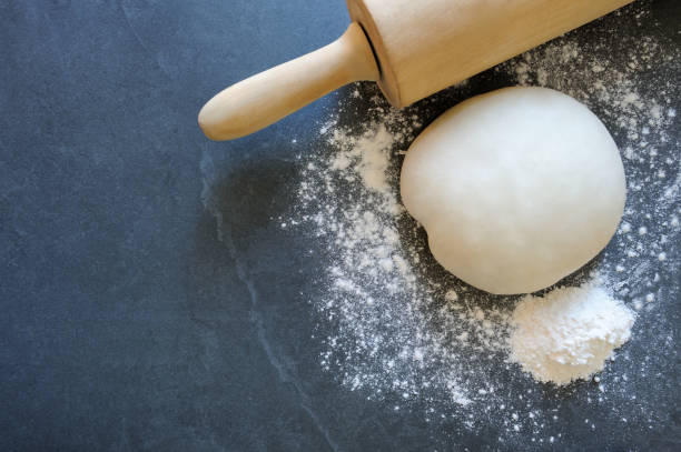 istock Ball of dough with rolling pin for dumplings or pasta. 1272400763