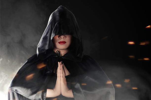 istock Asian witch woman with black cloak doing mystical ritual 1272402142