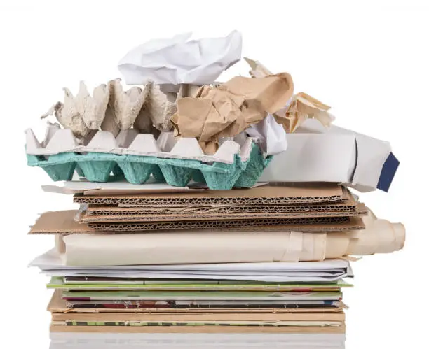 Photo of Recycling concept. Recyclable cardboard and paper isolated on white