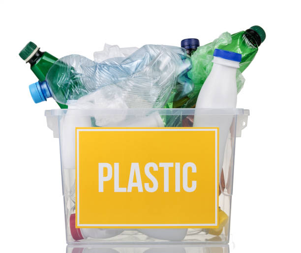 istock Recycling concept. Container with plastic bottles and plastic inscription on yellow isolated 1272403515