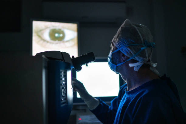 Doctor doing an exam or surgery, looking at images in monitor Doctor doing an exam or surgery, looking at images in monitor ophthalmologist photos stock pictures, royalty-free photos & images