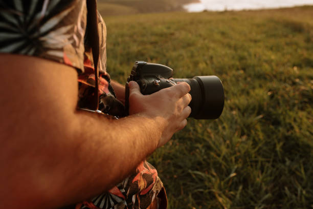 istock Detail of a DSLR camera held by a man 1272406937