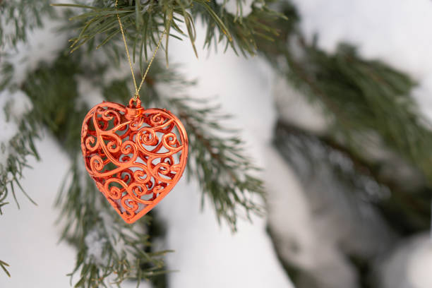 istock Christmas tree and heart  on  background  with  snow. 1272407684