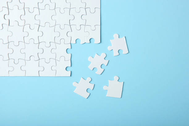 istock White puzzle on a colored background top view. 1272407881
