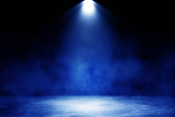 istock Studio dark room with blue lighting effect and fog on concrete floor in black background. 1272408015