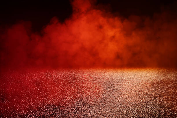 istock Empty wet asphalt road with red lighting effect and fog or mist in dark background. 1272408151