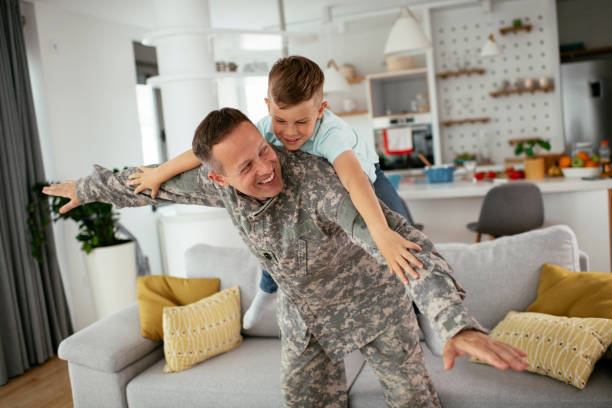 istock Soldier having fun with his son at home. 1272409320