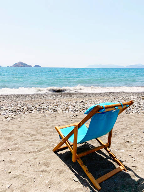 istock Wooden deck chairs on the beach 1272409510
