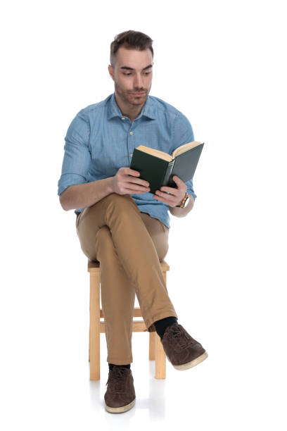 istock Serious smart casual man focusing on reading a book 1272409526