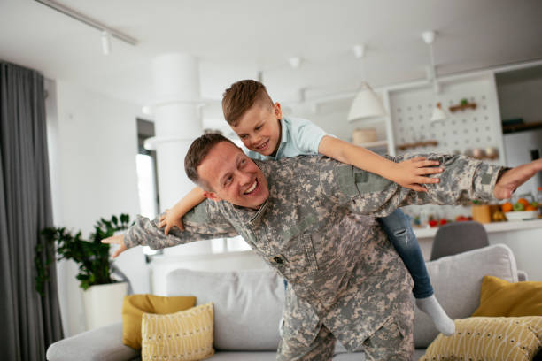 istock Soldier having fun with his son at home. 1272409659