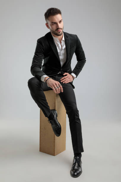 istock handsome businessman looking away while sitting and resting his hands 1272409824