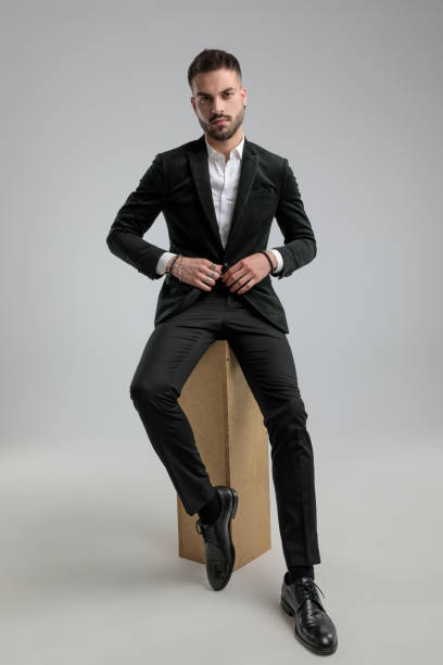 istock businessman with attitude holding hands on his jacket's button 1272409911