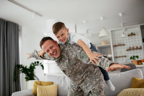 istock Soldier having fun with his son at home. 1272409998