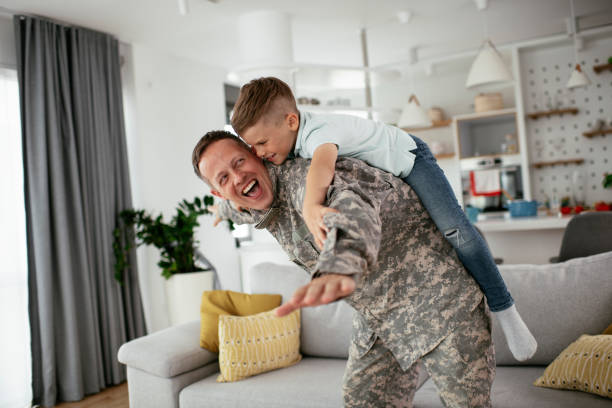 istock Soldier having fun with his son at home. 1272410051