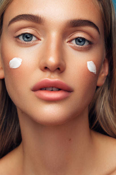 istock Beautiful girl with cream on her face 1272410075