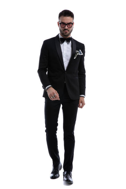istock dramatic cool guy in tuxedo holding hands in fashion pose 1272410236