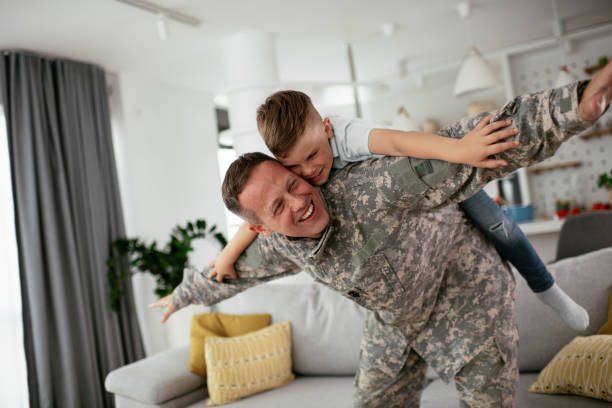 istock Soldier having fun with his son at home. 1272410874