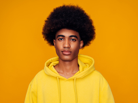 African American Man With Afro Hair Wearing Hoodie And Standing Over  Isolated Yellow Background Stock Photo - Download Image Now - iStock