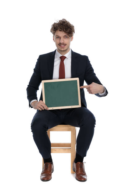 istock handsome businessman holding a board on his lap 1272410985