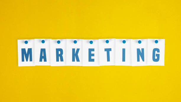istock Note papers that write Marketing pinned on yellow background. 1272411110