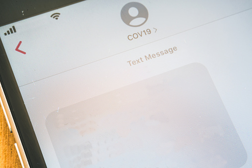 A received COVID-19 SMS shown in a smartphone screen. A blank text message space. You can any text you like.